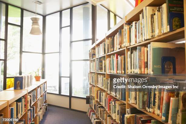 library with sun shining through windows - library empty stock pictures, royalty-free photos & images