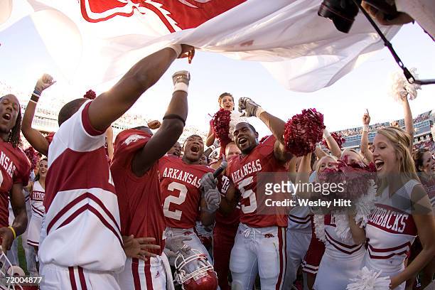 Arkansas Razorback players and cheerleaders celebrate after a game against the Alabama Crimson Tide at Donald W. Reynolds Stadium on September 23,...