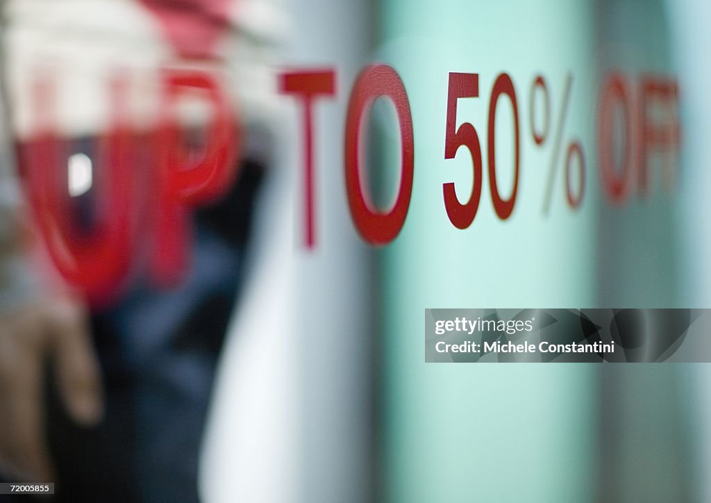 Up to 50% off text on shop window