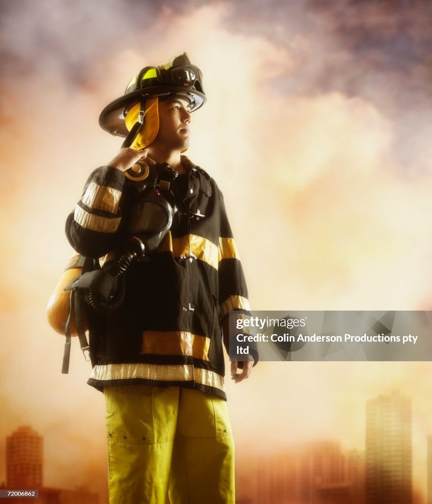 Male fire fighter with smoky background