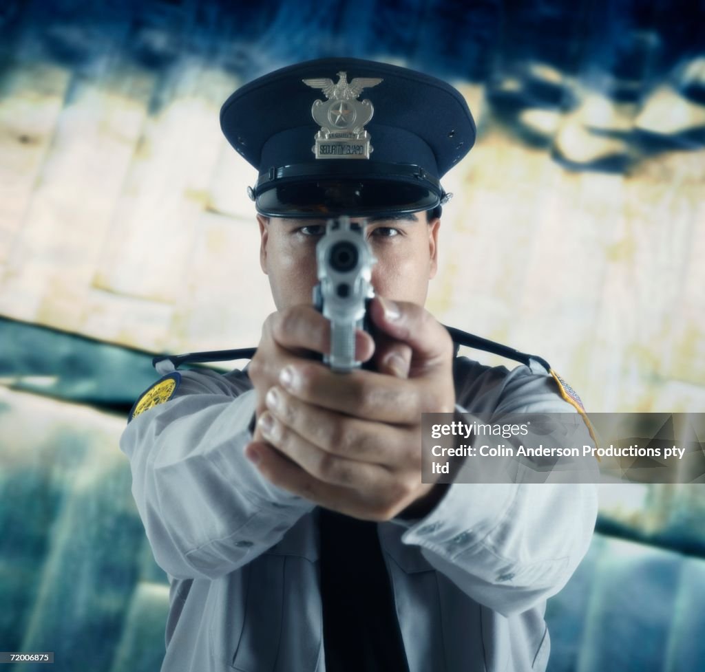 Male police officer aiming gun