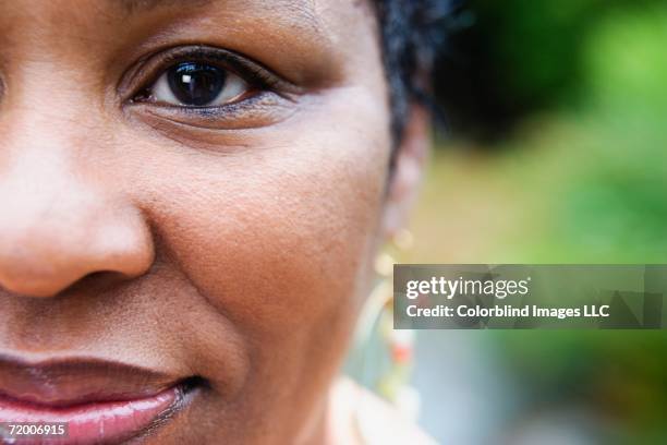 close up of african woman - close up woman eyes stock-fotos und bilder