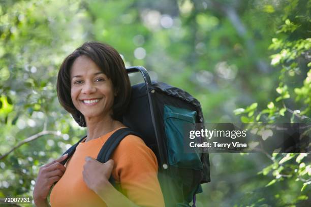 african woman wearing backpack in woods - terry woods stock pictures, royalty-free photos & images