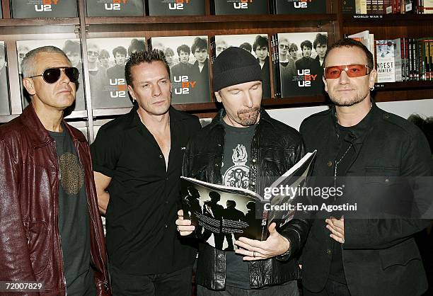 Band members Adam Clayton, Larry Mullen Jr., The Edge and Bono make an appearance at The Union Square Barnes & Noble bookstore to sign copies of...