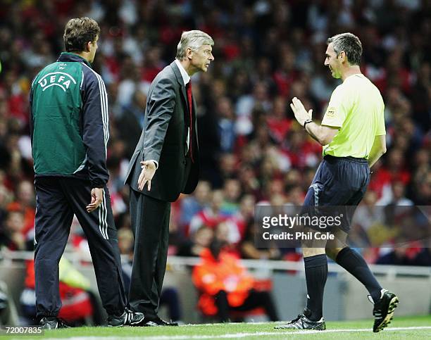Arsene Wenger , the Arsenal manager talks with the match referee Stefano Farina on the touchline during the UEFA Champions League Group G match...