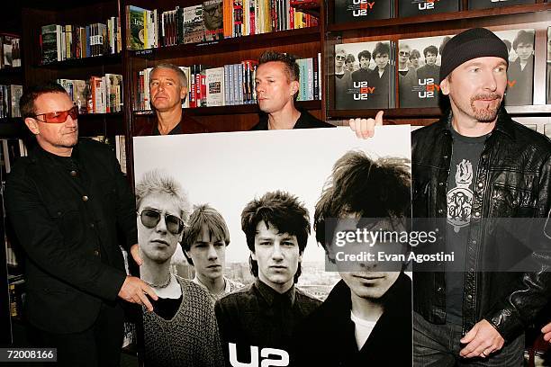 Band members Bono, Adam Clayton, Larry Mullen Jr. And The Edgemake an appearance at The Union Square Barnes & Noble bookstore to sign copies of their...