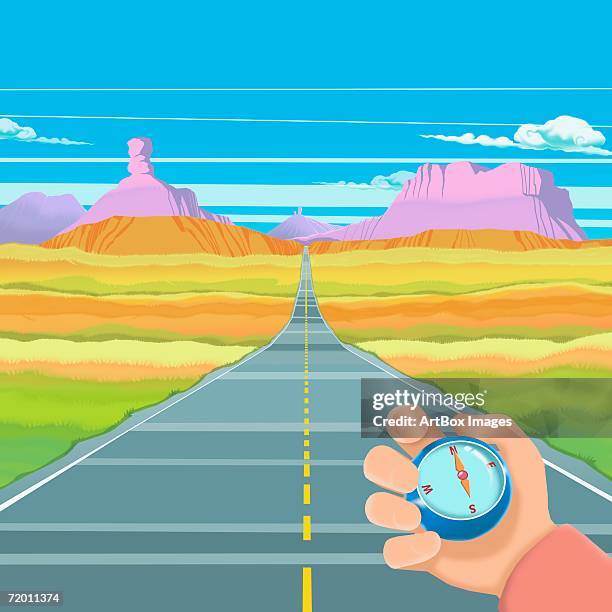 close-up of a person's hand holding a compass over a two lane highway - two lanes to one stock illustrations