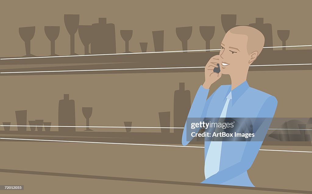 Close-up of a bartender using a mobile phone