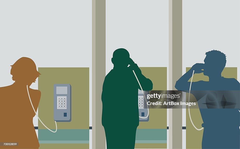 Silhouette of two young men and a young woman talking on pay phones