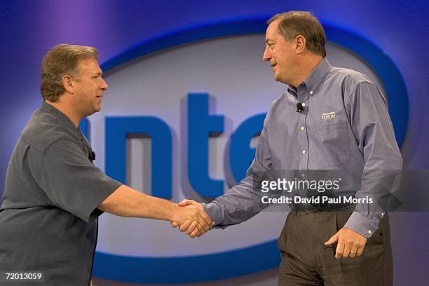 Intel Corporation CEO Paul Otellini and Phil Schiller, senior vice president of worldwide marketing for Apple, shake hands onstage at the opening of...