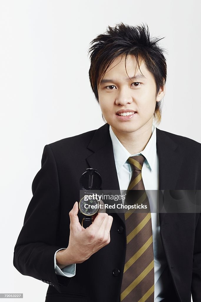 Portrait of a businessman holding a compass