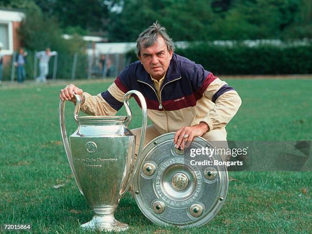 Ernst Happel, head coach of Hamburg, poses with trophy's during the photo call of the Bundesliga team Hamburger SV at the Paul-Hauenschild sports...