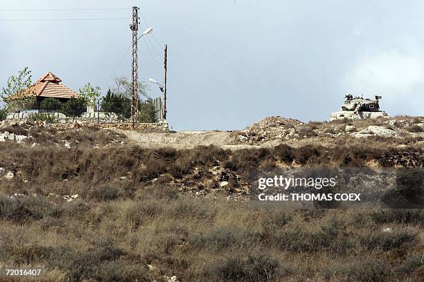 Alma Al-Shaab, LEBANON: An Israeli tank takes position on the top of a hill near the southern Lebanese border village of Alma al-Shaab, 05 September...