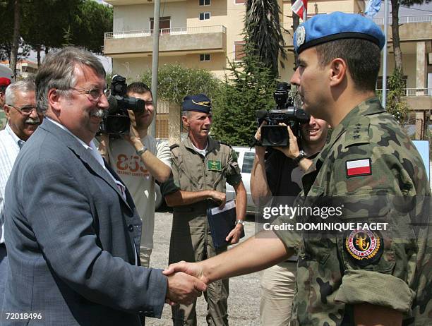 Belgian Defence Minister Andre Flahaut shakes hand with a Polish UNIFIL soldier during his visit at the UNIFIL camp in Tibnine in South Lebanon, 24...