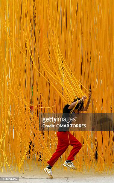 Child plays inside the plastic art work "Penetrables" of Venezuelan artist Jesus Rafael Soto, in front of the Beaux-Arts palais in Mexico City on...