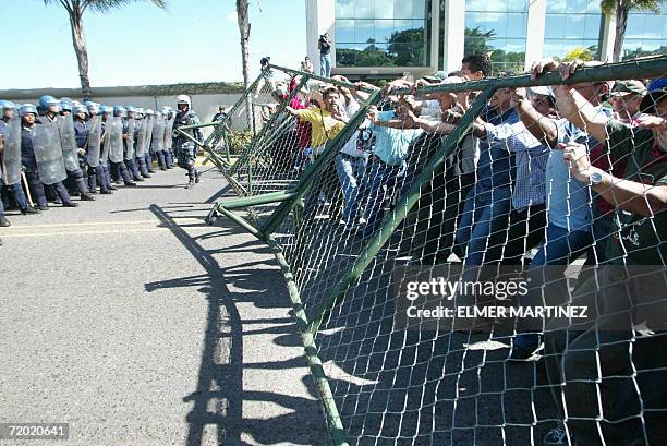 Tegucigalpa, HONDURAS: Maestros hondurenos quitan por la fuerza una valla metalica de seguridad instalada por la Policia Nacional en el bulevar Juan...