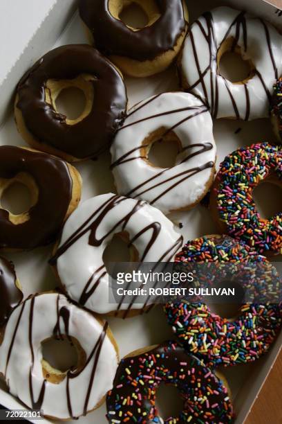 Dozen doughnuts are pictured outside a Dunkin' Donuts store 27 September 2006 in Miami, Florida. Three years after New York City banned smoking in...