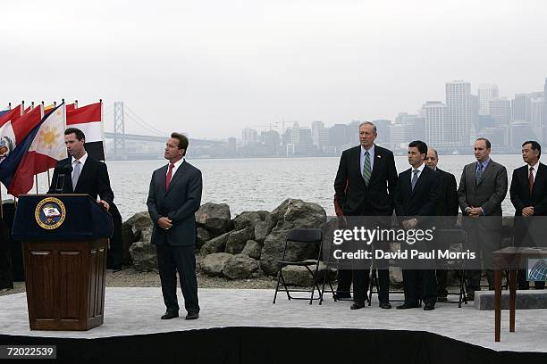 San Francisco Mayor Gavin Newsom speaks as California Governor Arnold Schwarzenegger listens before he signs landmark legislation bill AB-32, the...