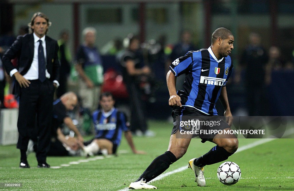 Inter Milan's Adriano (R) is closely wat