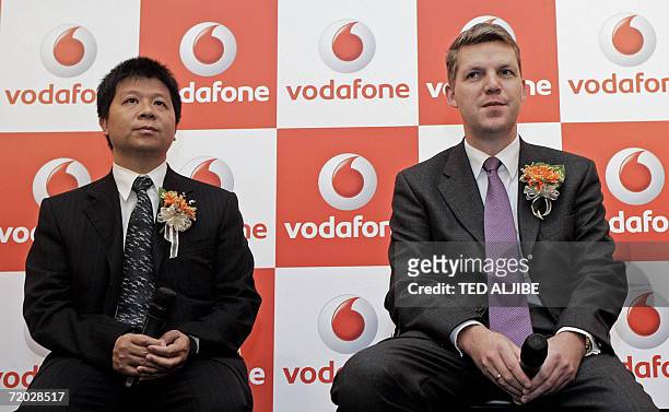 Jens Schulte-Bockum, Vodafone's global director of terminals and Guo Ping, president of Huawei terminals business attend a press preview of the...