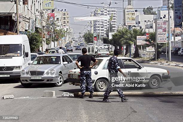 Palestinian security men close a road during a protest by sercurity forces over unpaid salaries on September 28, 2006 in Gaza City, Gaza Strip....