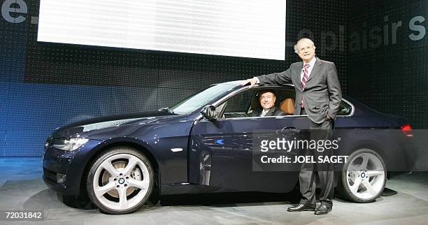 Chairman Norbert Reithofer poses at the wheel of the new BMW Coupe serie 3 with BMW research and development head Burckart Goschel during the press...