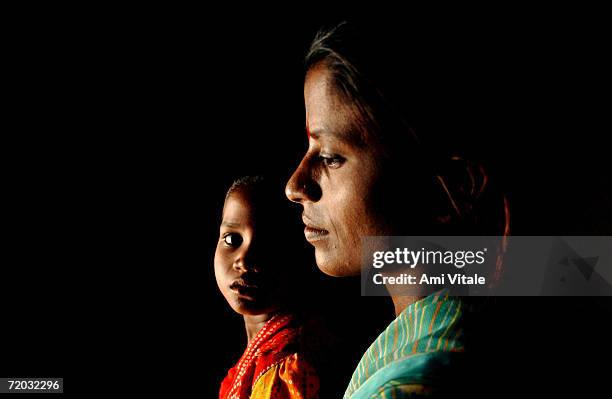 Yellama relaxes in her home with her daughter Anitha in this photo taken on August 23, 2005 in Mehbubnagar, in Andhra Pradesh, India. She is a...