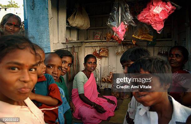 Bellama, sits inside her food stand that she was able to set up after the government gave her a loan, in this photo taken on August 23, 2005 in...