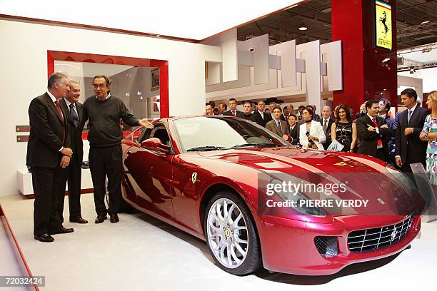 Ferrari Vice President Piero Ferrari, Ferrari chief executive Amideo Felisa and Fiat Chairman Sergio Marchionne pose in front of a Ferrari GTB...