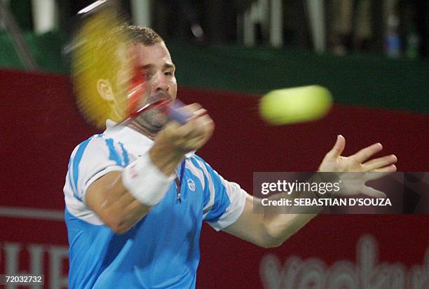 Italian tennis player Stefano Galvani plays a forehand return to Croatia's Mario Ancic in the second round of The ATP Mumbai Open,28 September 2006....