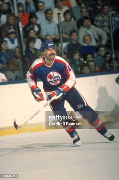French-born professional hockey player Paul MacLean, forward for the Winnipeg Jets, skates on the ice during a game with the New York Islanders at...