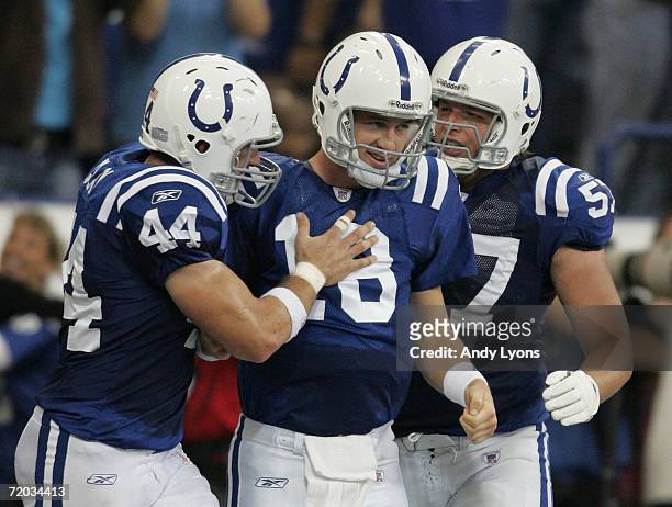 Peyton Manning of the Indianapolis Colts celebrates his rushing touchdown with Dallas Clark and Dylan Gandy against the Jacksonville Jaguars...