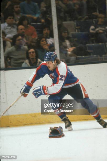 Swedish professional hockey player Willy Lindstrom, right wing for the Winnipeg Jets, skates on the ice past a discarded goalie blocker during a game...