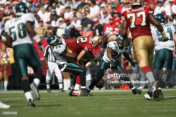 Defensive end Darren Howard of the Philadelphia Eagles tackles tight end Eric Johnson of the San Francisco 49ers on September 24, 2006 at Monster...