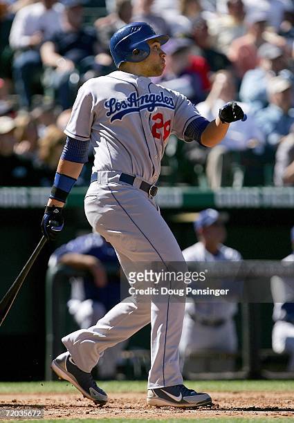 James Loney of the Los Angeles Dodgers follows through on his first inning grand slam off of starting pitcher Byung-Hyun Kim of the Colorado Rockies...