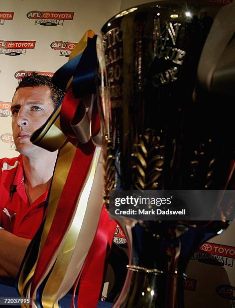Leo Barry of the Sydney Swans sits behind the Premiership Cup during a press conference in the Treasury on Spring Street during the AFL Grand Final...
