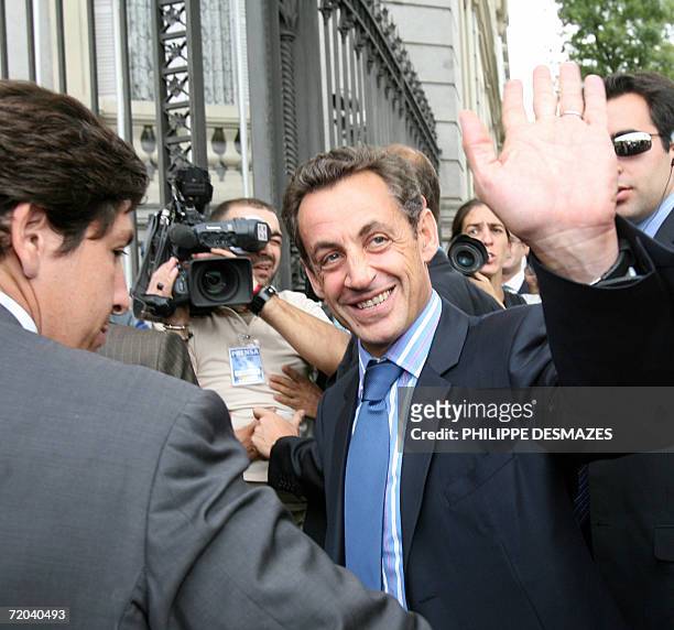 French Interior Minister Nicolas Sarkozy waves on arrival for the eight-country round table on immigration in Madrid, 29 September 2006. Ministers...