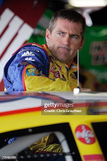 Bobby Labonte, driver of the Cheerios/Betty Crocker Dodge, climbs out of his car while in the garage, during practice for the NASCAR Nextel Cup...