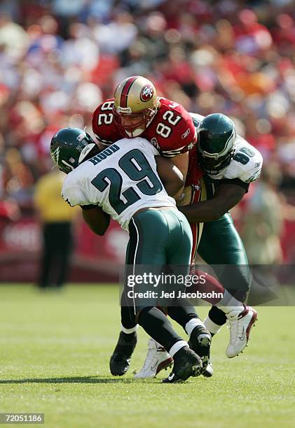 Tight end Eric Johnson of the San Francisco 49ers gets tackled by Philadelphia Eagles Roderick Hood and Darren Howard at Monster Park on September...