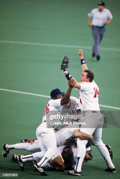 Kent Hrbek of the Minnesota Twins celebrates with teammates after defeating the St. Louis Cardinals in game seven of the 1987 World Series for the...