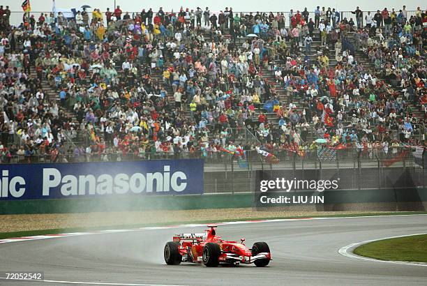 German Ferrari driver Michael Schumacher powers his race car during the qualifying session in Chinese Grand Prix at the Shanghai International...