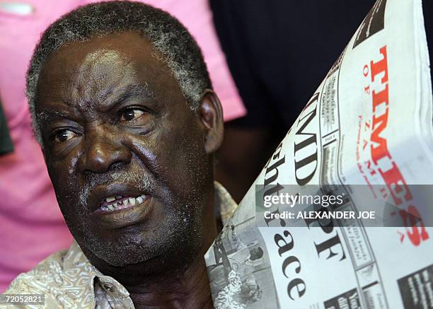 Michael Sata, opposition leader of the Patriotic Front party displays a loal daily 30 September 2006 at a media confrence in Lusaka. Sata warned of...