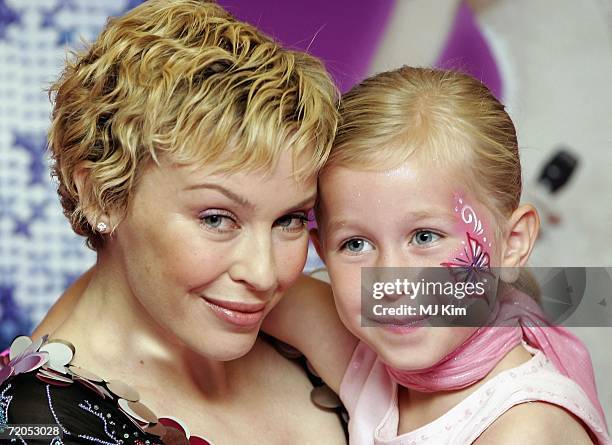 Singer Kylie Minogue with her fan, Megan Hondius , during a signing of her new book 'The Showgirl Princess' at Waterstone's Oxford Street on...