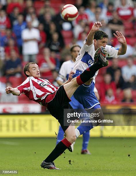 Alan Quinn of Sheffield United battles for the ball with Fabio Rochemback of Middlesbrough during the Barclays Premiership match between Sheffield...