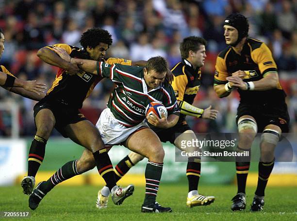 James Buckland of Leicester Tigers is tackled by Colin Charvis of Dragons during the EDF Energy Anglo Welsh Cup match between Leicester Tigers and...