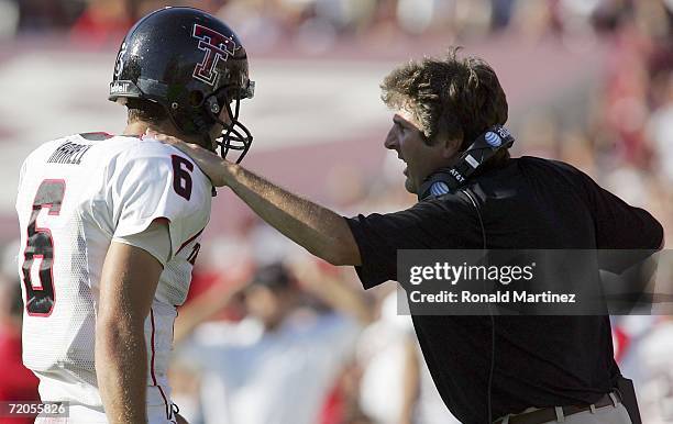 Quarterback Graham Harrell of the Texas Tech Red Raiders talks with head coach Mike Leach during play against the Texas A&M Aggies at Kyle Field on...