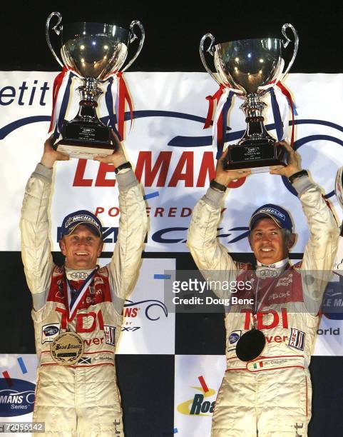 Rinaldo Capello and teammate Allan McNish of the Audi Sport North America Audi R10 celebrate after their victory in the American Le Mans Series Petit...