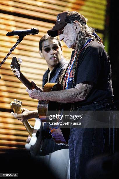 Henry Garza of Los Lonely Boys and Willie Nelson perform at Farm Aid on September 30, 2006 at The Tweeter Center in Camden, New Jersey. Organized in...