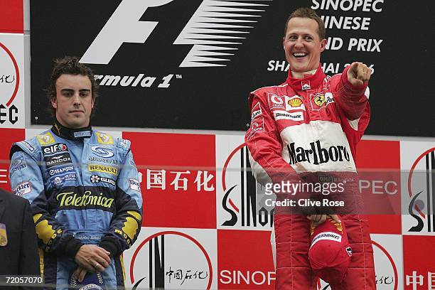 Michael Schumacher of Germany and Ferrari celebrates on the podium as Fernando Alonso looks on after the Formula One Chinese Grand Prix at Shanghai...
