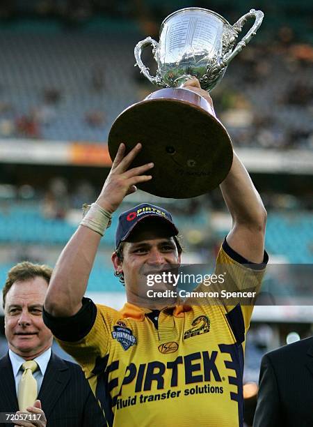 Henry Perenara holds the 2006 Premier League trophy aloft after winning the Grand Final between the Parramatta Eels and the Newtown Jets at Telstra...